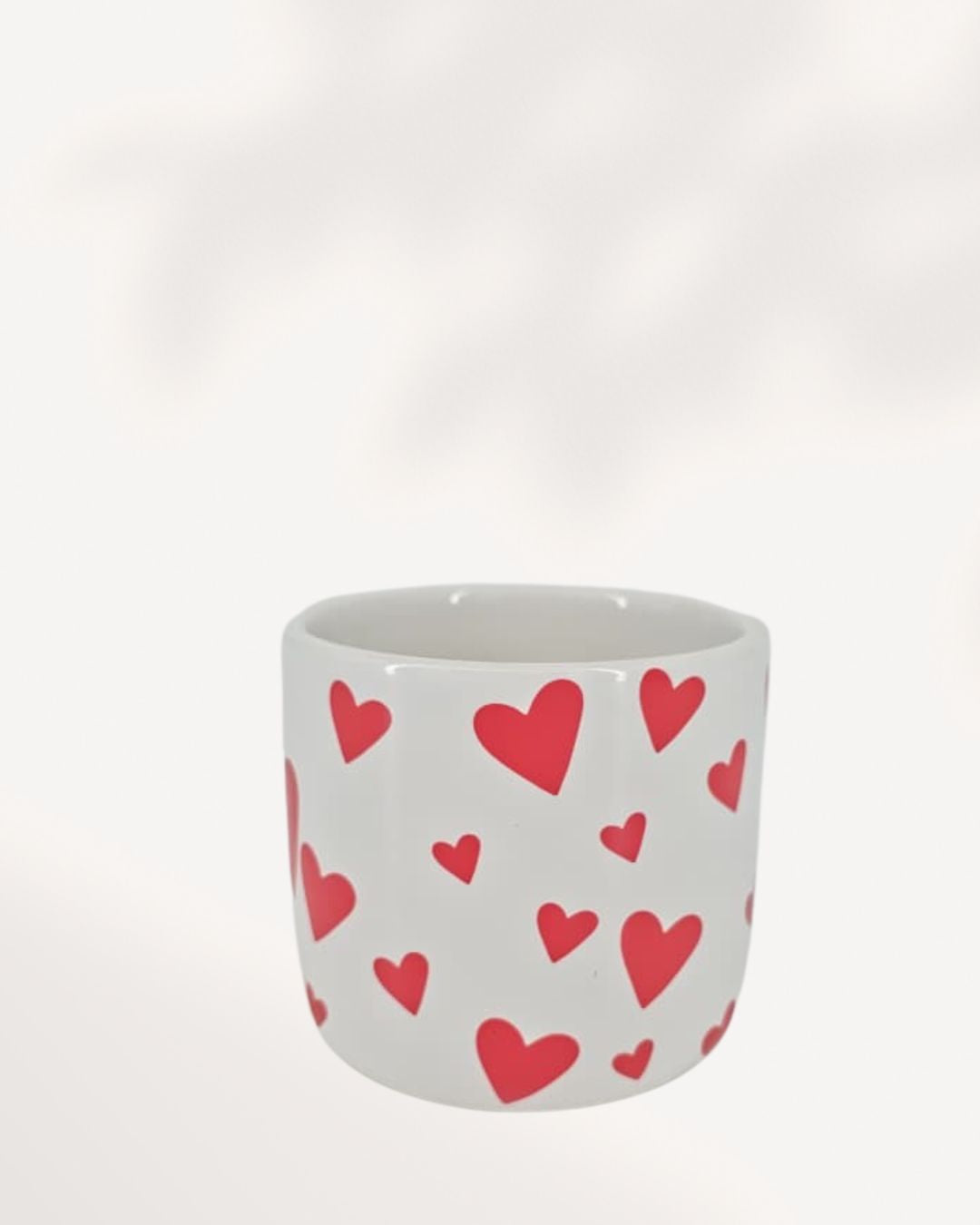You & Me Hearts Planter front top view, white ceramic and clay planter with scattered red hearts, stylish 3.5 inch cachepot for indoor plants, decorative heart themed planter for desks, shelves and windowsills, modern romantic home décor plant pot