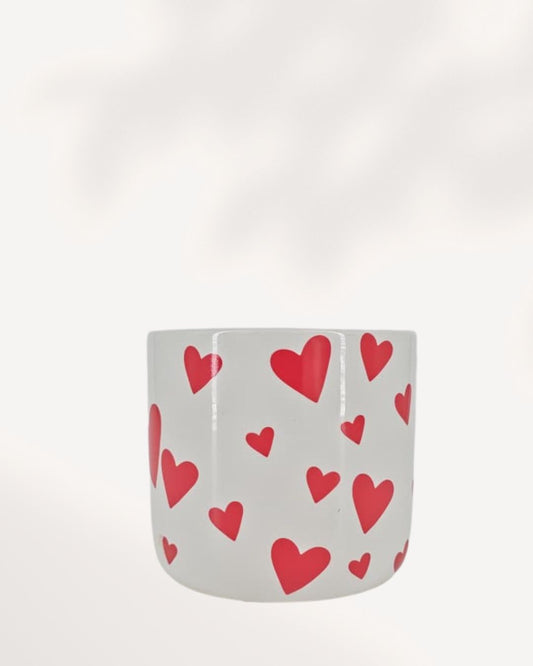 You & Me Hearts Planter front top view, white ceramic and clay planter with scattered red hearts, stylish 3.5 inch cachepot for indoor plants, decorative heart themed planter for desks, shelves and windowsills, modern romantic home décor plant pot